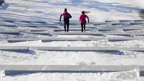 Fit Couple Running on Stairs in Winter