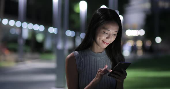 Woman use of mobile phone at outdoor