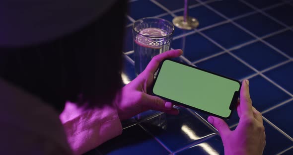 Close Up of Mobile with Chroma Key Screen in Female Hands