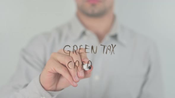 Green Tax Credits Writing on Screen with Hand