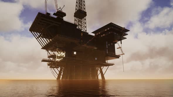 Offshore Jack Up Rig in The Middle of The Sea at Sunset Time alt
