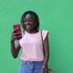 An African-American woman is talking on a video link on her phone with a friend - VideoHive Item for Sale