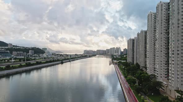 Aerial riser over Shing Mun river reveals modern Shatin neighbourhood, Hong Kong
