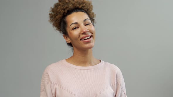 Portrait of a Beautiful Young Woman with Black Curly Hair