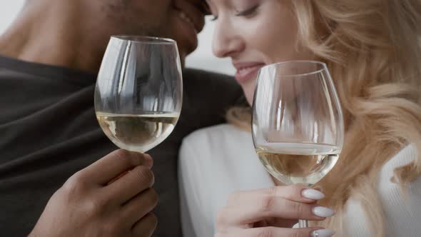 Loving Multicultural Couple Drinking Wine During Romantic Date Indoors Cropped