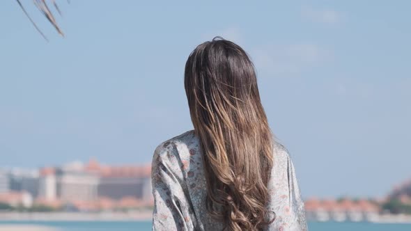 Young Woman in a Bikini Takes Off Her Clothes