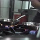 Chef Heats Oil and Puts Garlic Into Pan on Stove in Kitchen - VideoHive Item for Sale