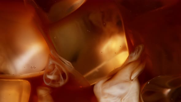 Super Slow Motion Shot of Pouring Cream Into Ice Coffee at 1000 Fps alt