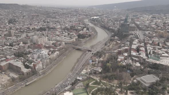 Aerial View of Galaktion Tabidze Bridge over Kura river in the centre of Tbilisi. Georgia 2021 April