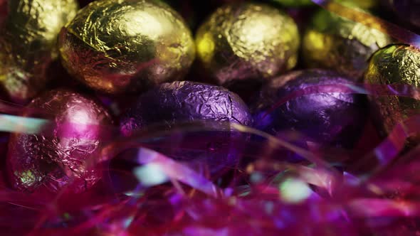 Rotating shot of colorful Easter candies on a bed of easter grass - EASTER 