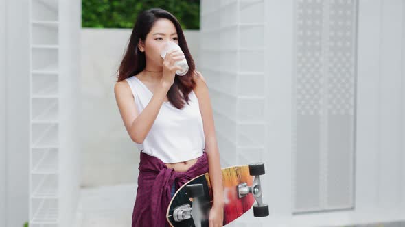 Attractive Asian woman drinking milk and smiling at home close up face.healthy life