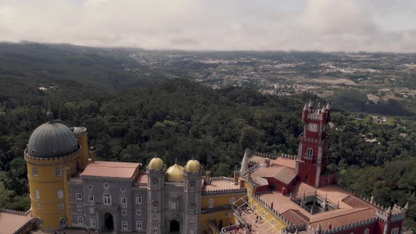 People visiting  Pena Palace, Sintra, against Natural Park forest. Aerial view