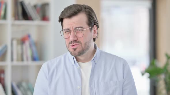 Portrait of Disappointed Man in Glasses Feeling Shocked