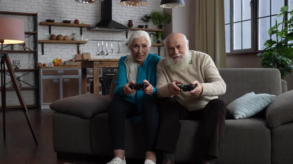 Joyful Elderly People Playing Video Games Indoors