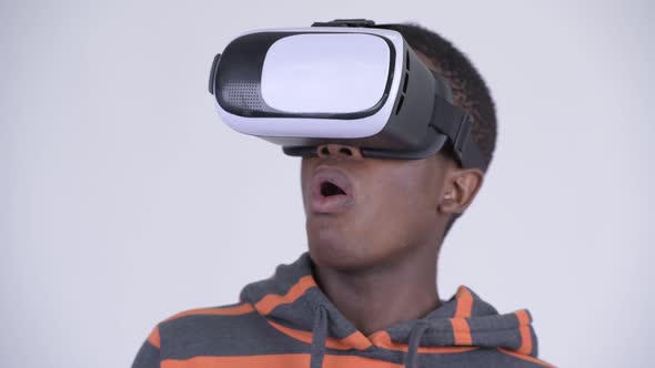 Face of Young Handsome African Man Using Virtual Reality Headset