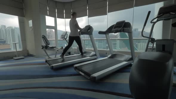 Woman exercising on treadmill in the gym