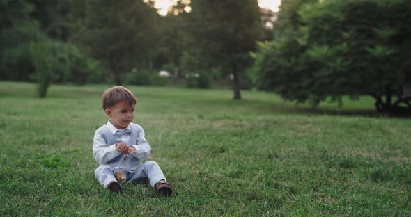 Attractive Little Boy in a Casual Suit Eating
