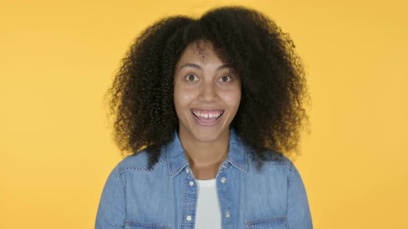 African Woman Yes By Head Shake, Yellow Background 