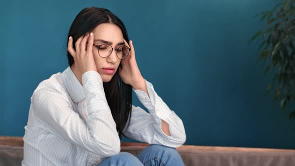 Stressful Young Mixed Race Woman in Glasses Massaging Temples