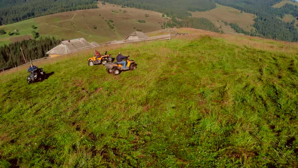 Group of Friends Driving Quad Bikes on a Mountain Slope