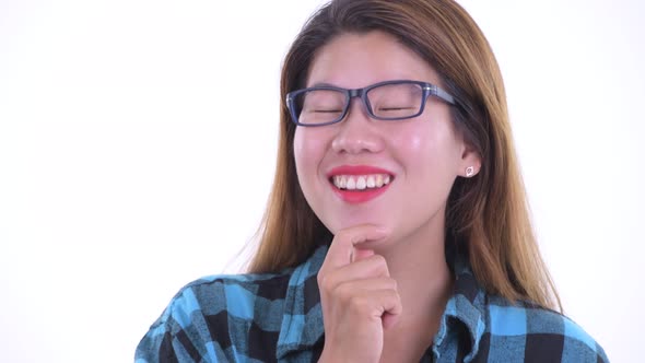 Face of Happy Young Asian Hipster Woman Thinking and Looking Up