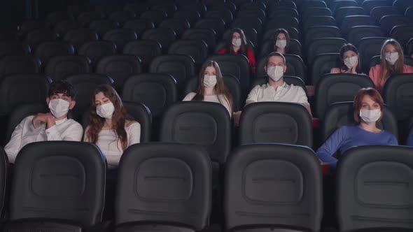 Young Adults Wearing Face Masks in Cinema Hall.