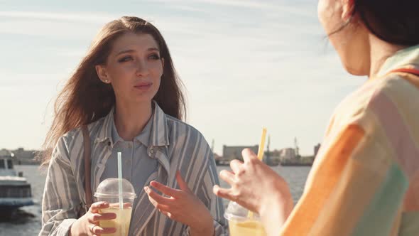 Female Friends Chatting on Waterfront