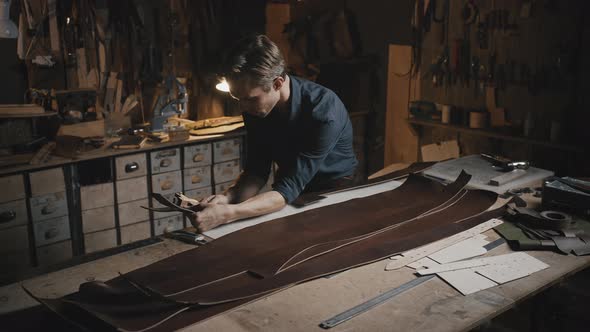 Young Professional Tailor Making Leather Belts at His Workshop Creating Handmade Original