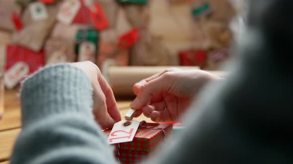 Hands Making Christmas Advent Calendar at Home