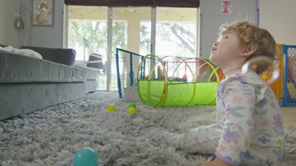 Baby Girl Enjoying Bubbles at Home