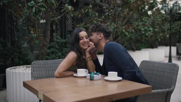 Boy Whispering in Girl's Ear