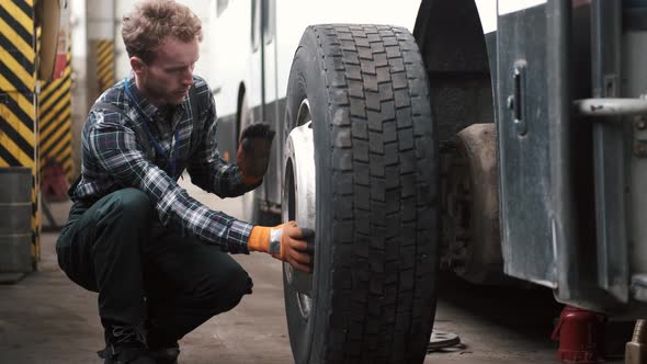 Technical Engineer Changing Tire of a Bus or Truck