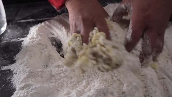 chef kneading preparation with flour and water