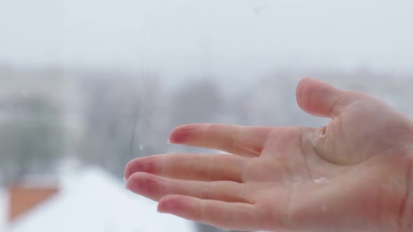 Slow Motion of Snow Falling Into Female Hand