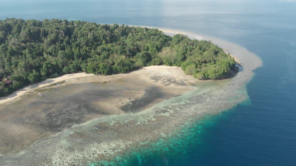 Aerial: flying over tropical Ai island coral reef sand beach Banda Islands Maluk