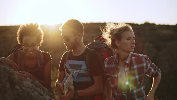 Caucasian Male and Female Using Map to Find Right Way While African American Woman Looking at