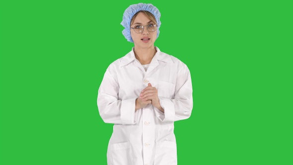 Beautiful doctor is talking while walking on a Green Screen