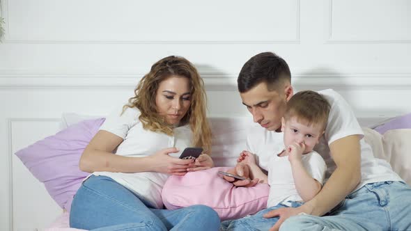 Parents are Looking in Their Mobile Phones Not Paying Attention to Their Child