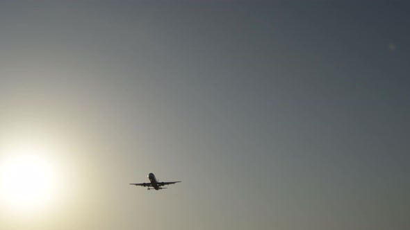 Airplane Passing in Landing at Sunset