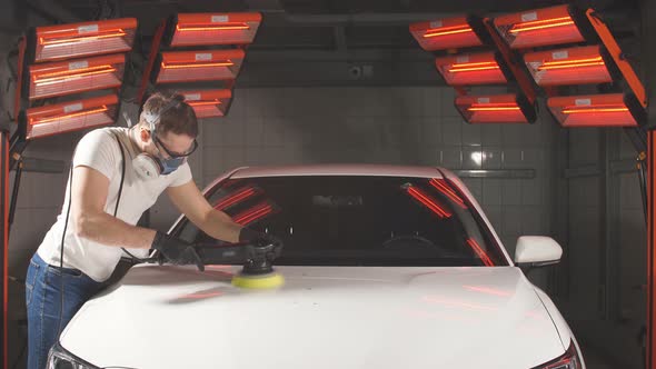 Master Polishes the Car in a Car Workshop.