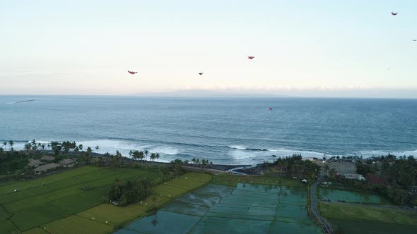 Kites Fly on the Ocean Shore Near the Rice Terraces in the Evening