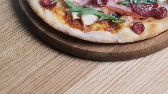 Appetizing Pizza on a Wooden Board in a Restaurant