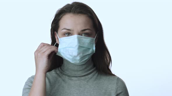 Girl Removes Face Mask Under Remains One More. Protection of Infection Covid-19