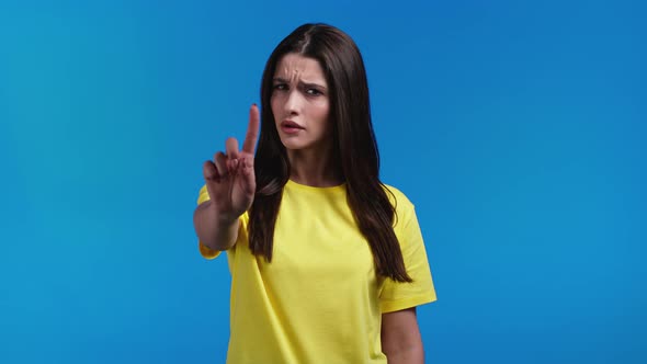 Portrait of Serious Woman Showing Rejecting Gesture By Stop Finger Sign