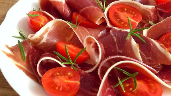 Jamon with tomatoes and rosemary.