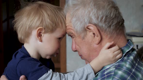 Old Man And Baby Play Game Together Laughing In House