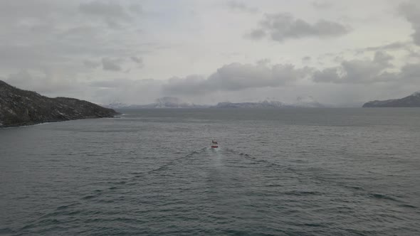 Commercial fishing boat heading out to open ocean, drone follow cam