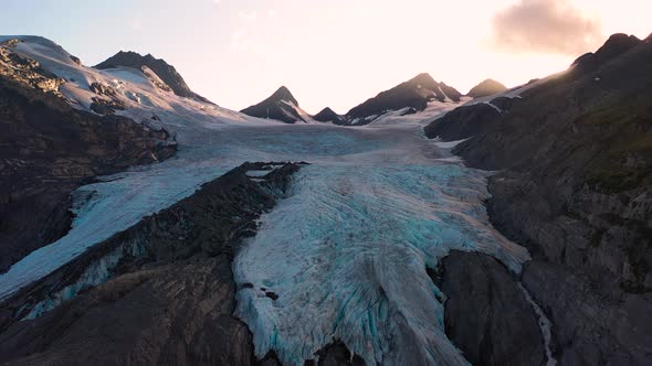 Snow-capped mountain slope under a shining sunlight