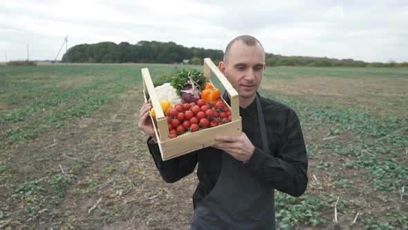 Farmer Holding a Box of Freshly Picked Organic Vegetables