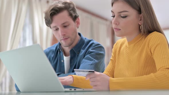 Serious Office Colleagues Making Online Payment on Laptop 